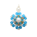 Handmade large statement pendant featuring vivid aquamarine blue faceted crystals, an iridescent golden centre crystal, white pearls and silver bead accents, with a decorative white pearl and silver bail, displayed on a silver-tone chain against a white background.