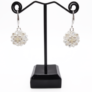 White pearl and clear crystal cluster earrings displayed on black jewellery stand