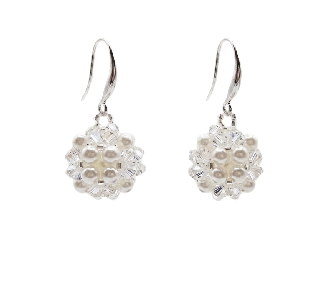 Handmade crystal and white pearl drop earrings with silver hooks on white background