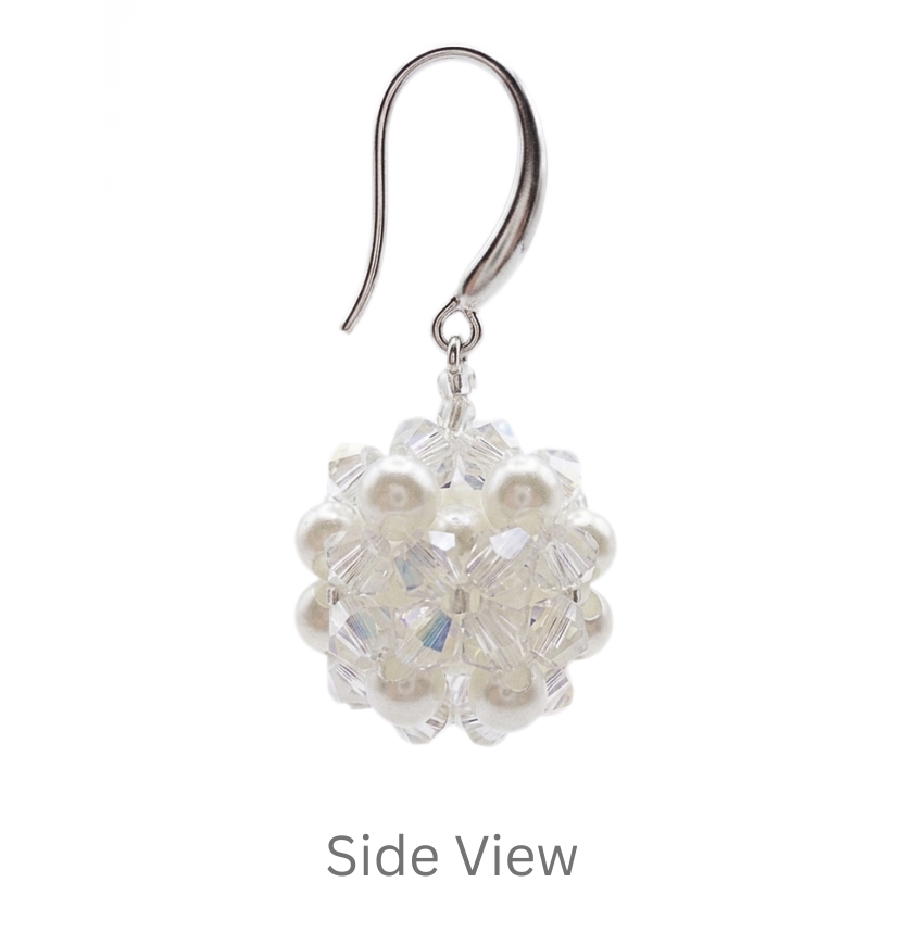Side view of handmade crystal and pearl cluster earring showing 3D ball shape and silver ear wire