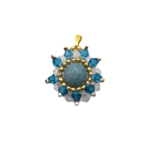 Aquamarine pendant featuring a smooth round aquamarine centre stone surrounded by teal blue and clear faceted crystals with gold and silver-tone bead accents and a gold-tone bail, photographed on a white background.
