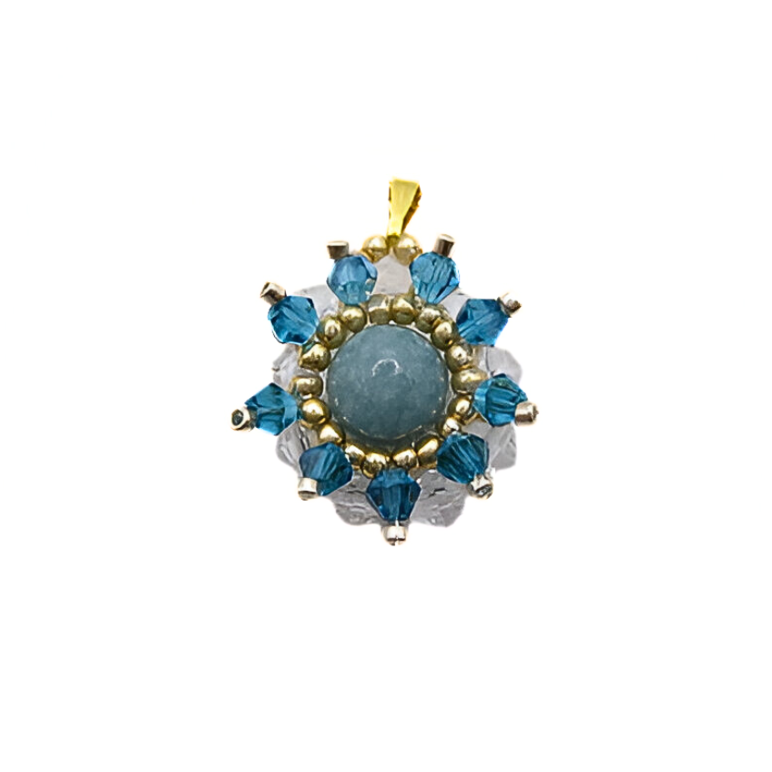 aquamarine-pendant-main Aquamarine pendant featuring a smooth round aquamarine centre stone surrounded by teal blue and clear faceted crystals with gold and silver-tone bead accents and a gold-tone bail, photographed on a white background.