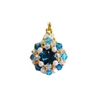 Blue crystal pendant featuring a large teal blue faceted centre stone surrounded by white pearls, aquamarine and clear crystals and gold bead accents, with a gold-tone bail, photographed on a white background.