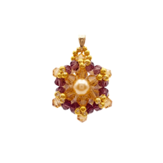 Crystal and pearl pendant with a champagne centre pearl surrounded by warm champagne faceted crystals and an outer purple crystals, accented throughout with gold beads, displayed against a white background.