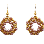 Handmade open hoop drop earrings featuring woven light brown faux pearl beads and gold-tone accent beads in an open circular lattice design, with gold-tone fish hook ear wires - flat lay view