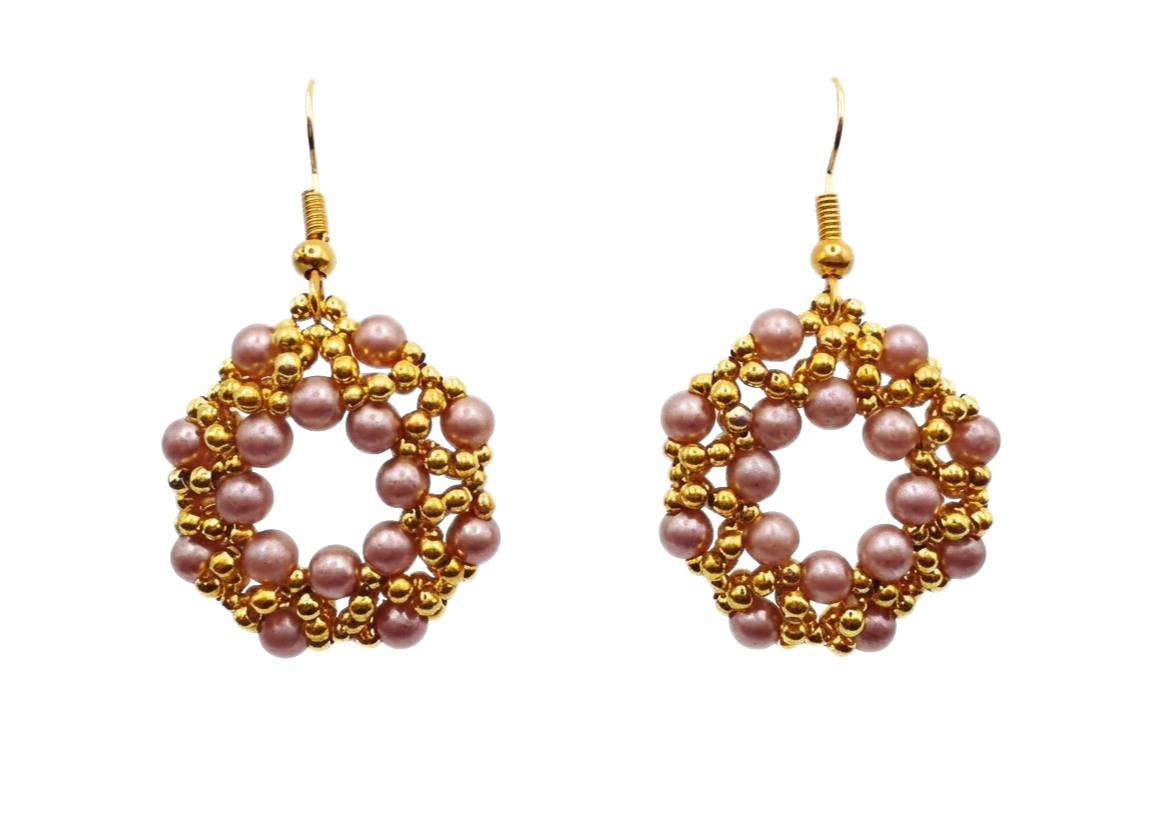 Handmade open hoop drop earrings featuring woven light brown faux pearl beads and gold-tone accent beads in an open circular lattice design, with gold-tone fish hook ear wires - flat lay view