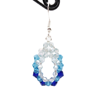 Detailed view of handmade blue ombre gradient crystal oval dangle earring on display stand, light blue to navy beaded open hoop, silver wire hook, shown against a white background.
