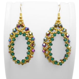 Emerald green and gold beaded teardrop hoop earrings displayed on a white jewellery stand, featuring iridescent rainbow crystals and gold seed beads with gold-tone ear wires.