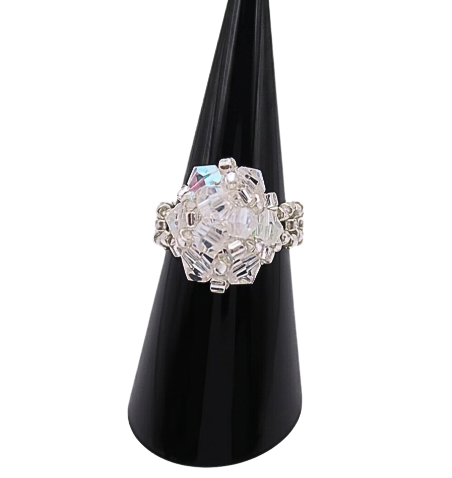 Handmade clear AB crystal cluster cocktail ring on black cone ring stand — iridescent aurora borealis crystals and silver-tone seed beads, handcrafted statement ring