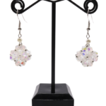 Handmade clear aurora borealis crystal beaded earrings with white pearl accent displayed on black jewellery stand, double-layered iridescent crystal pendant with silver ear wire