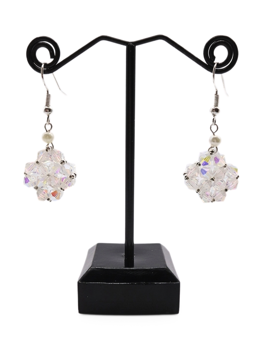 Handmade clear aurora borealis crystal beaded earrings with white pearl accent displayed on black jewellery stand, double-layered iridescent crystal pendant with silver ear wire
