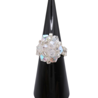 Handmade clear AB crystal cluster cocktail ring on black cone ring stand — iridescent aurora borealis crystals and silver-tone seed beads, handcrafted statement ring