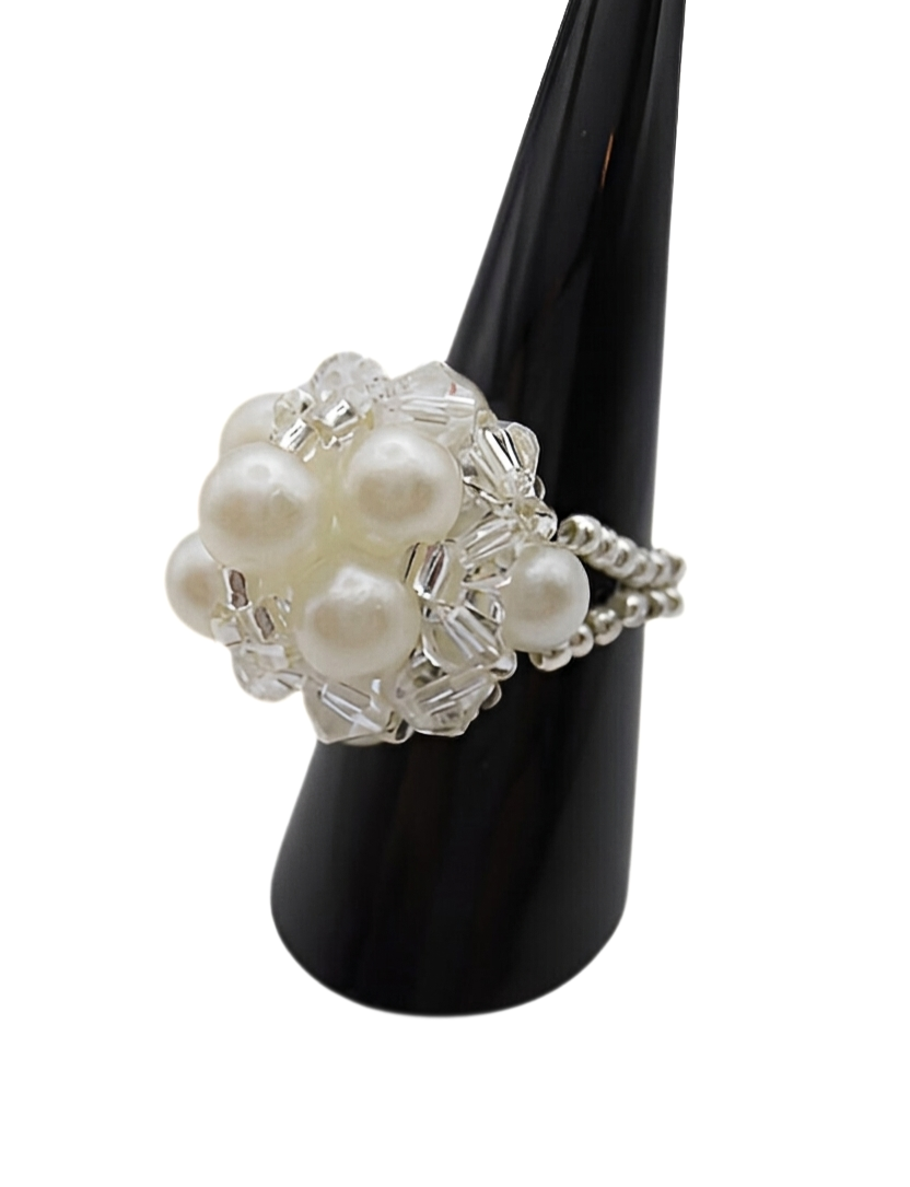 pearl-cocktail-ring-white-profile Profile view of white pearl cluster ring with clear crystal beads and silver beaded stretch band on black ring stand - handmade bridal jewellery.