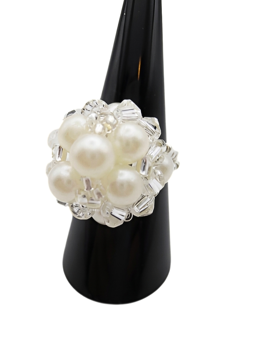 pearl-cocktail-ring-white-side-view Angled side view of handmade white pearl and clear crystal cluster cocktail ring on black display cone - bridal beaded statement ring