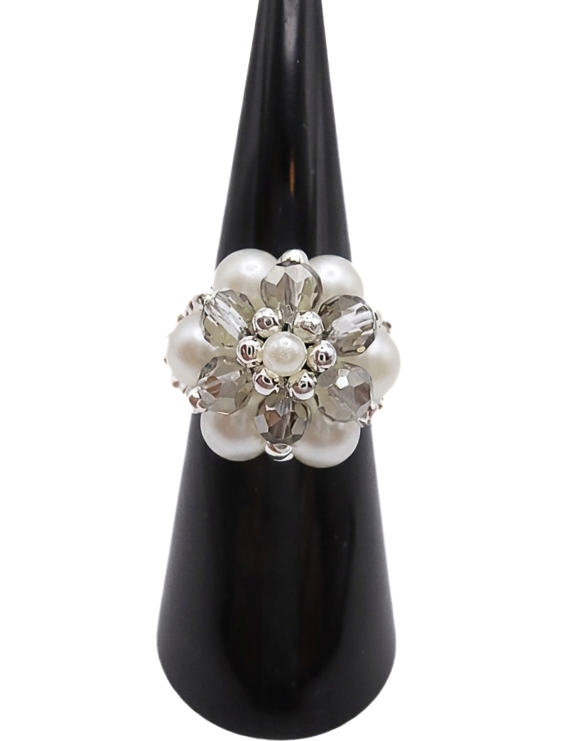 pearl-crystal-ring-grey-front Handmade cluster ring featuring white pearl beads, faceted light grey crystal beads, and silver-tone metal accents, displayed on a black ring cone — front view