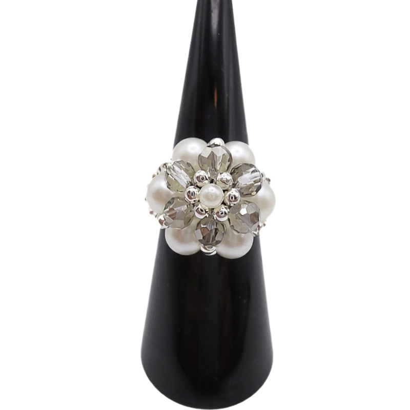 Handmade cluster ring featuring white pearl beads, faceted light grey crystal beads, and silver-tone metal accents, displayed on a black ring cone, shown against a white background