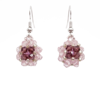 Handmade pink and purple crystal drop earrings with silver-tone hooks, beaded floral ball dangle design, shown against a white background.