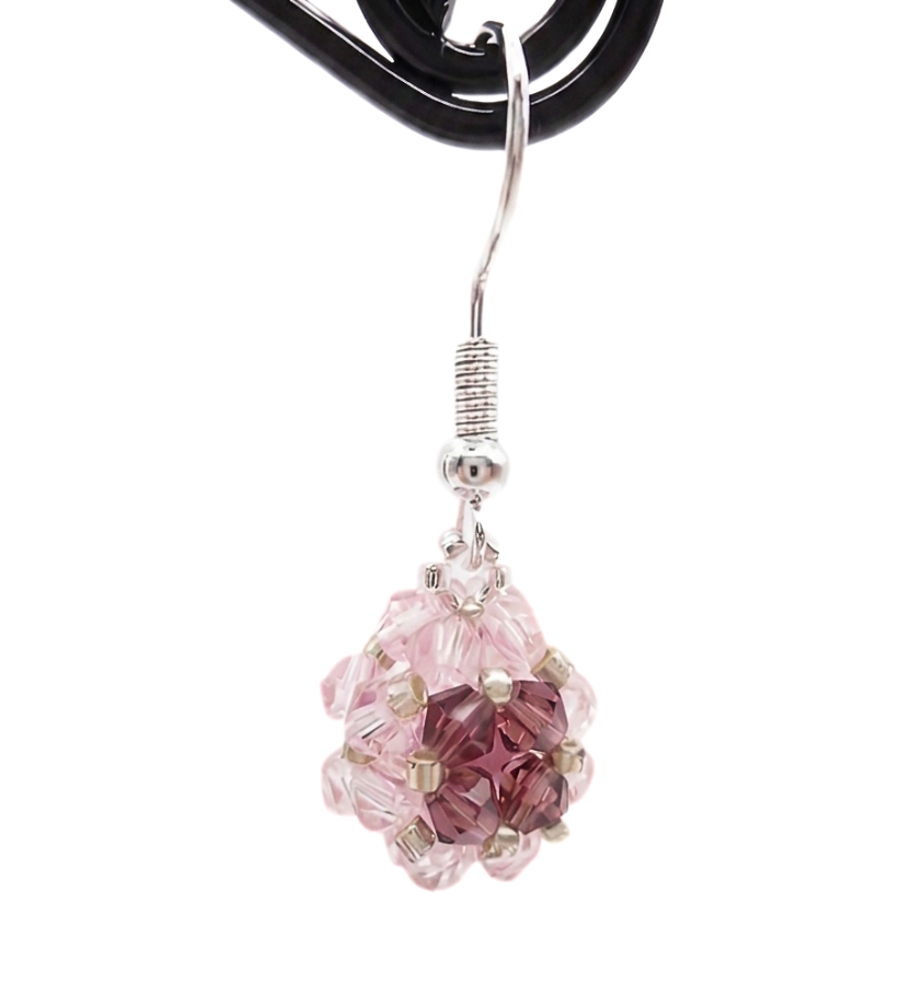 pink-purple-ball-earrings-side-view Side view of handmade pink and purple crystal beaded ball drop earring on display stand, silver ear hook wire, shown against a white background.
