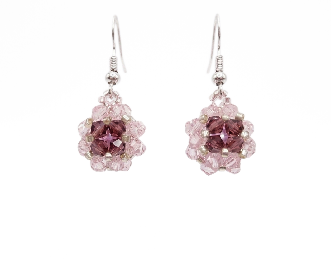 pink-purple-ball-earrings Handmade pink and purple crystal drop earrings with silver-tone hooks, beaded floral ball dangle design, shown against a white background.