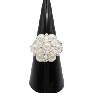 A handmade white pearl cluster cocktail ring on black display stand - featuring round pearls, clear crystal beads, and silver-tone metal accents, shown against a white background