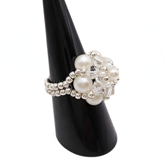 Side view of handmade pearl and crystal cluster ring displayed on black cone ring stand — white pearls, clear crystals, and silver-tone seed beads