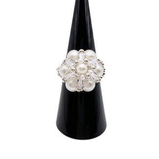 Front view of handmade white pearl cluster cocktail ring on black display stand - featuring round pearls, clear crystal beads, and silver-tone metal accents