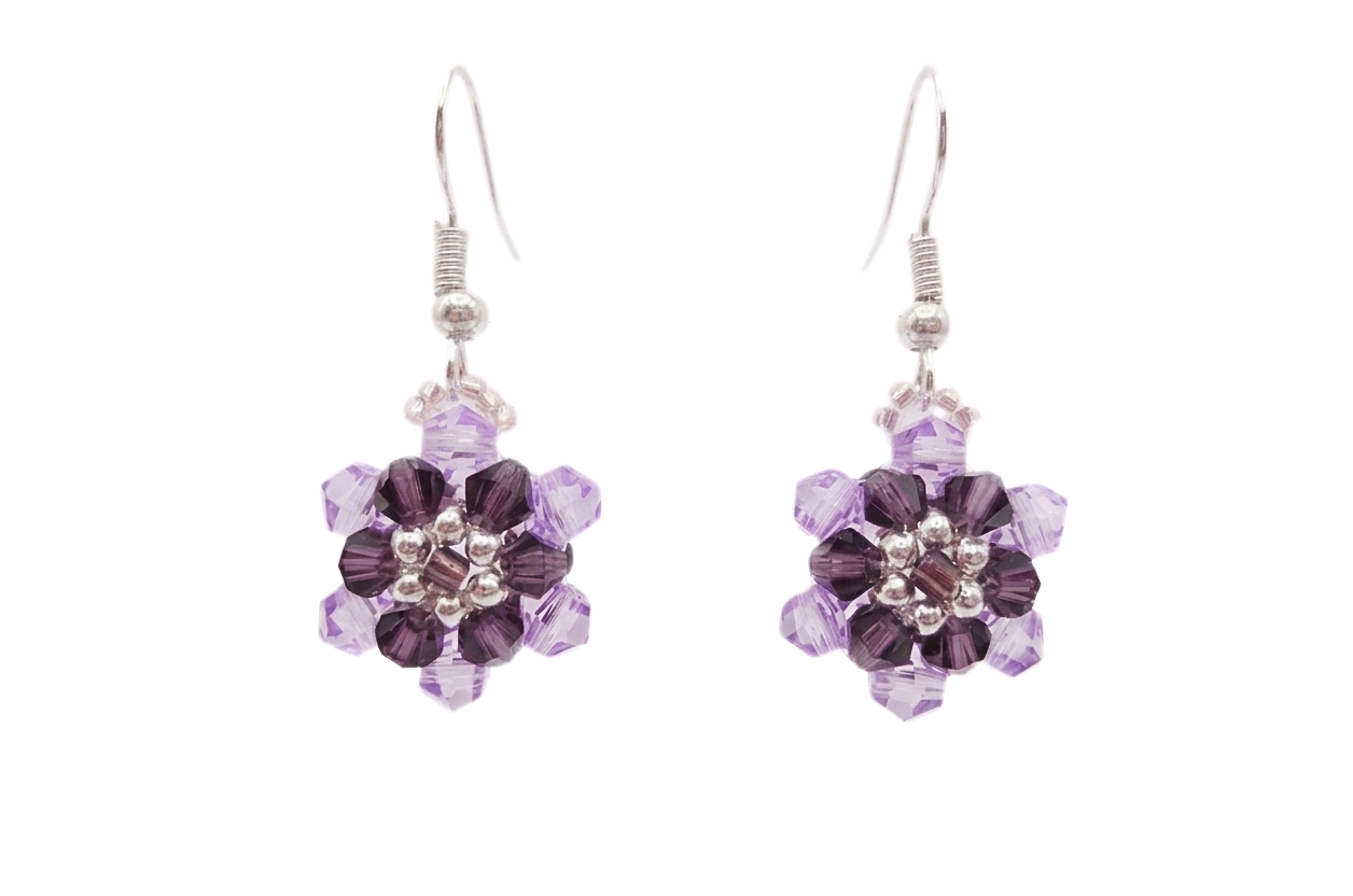 crystal-floral-earrings-white-background Purple and lilac crystal floral drop earrings with silver-tone hooks and bead accents on a white background