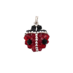 Handmade ladybug-shaped pendant featuring vivid red and black faceted crystals with a silver bead spine and border detailing, black crystal head and a silver-tone bail, photographed on a white background.