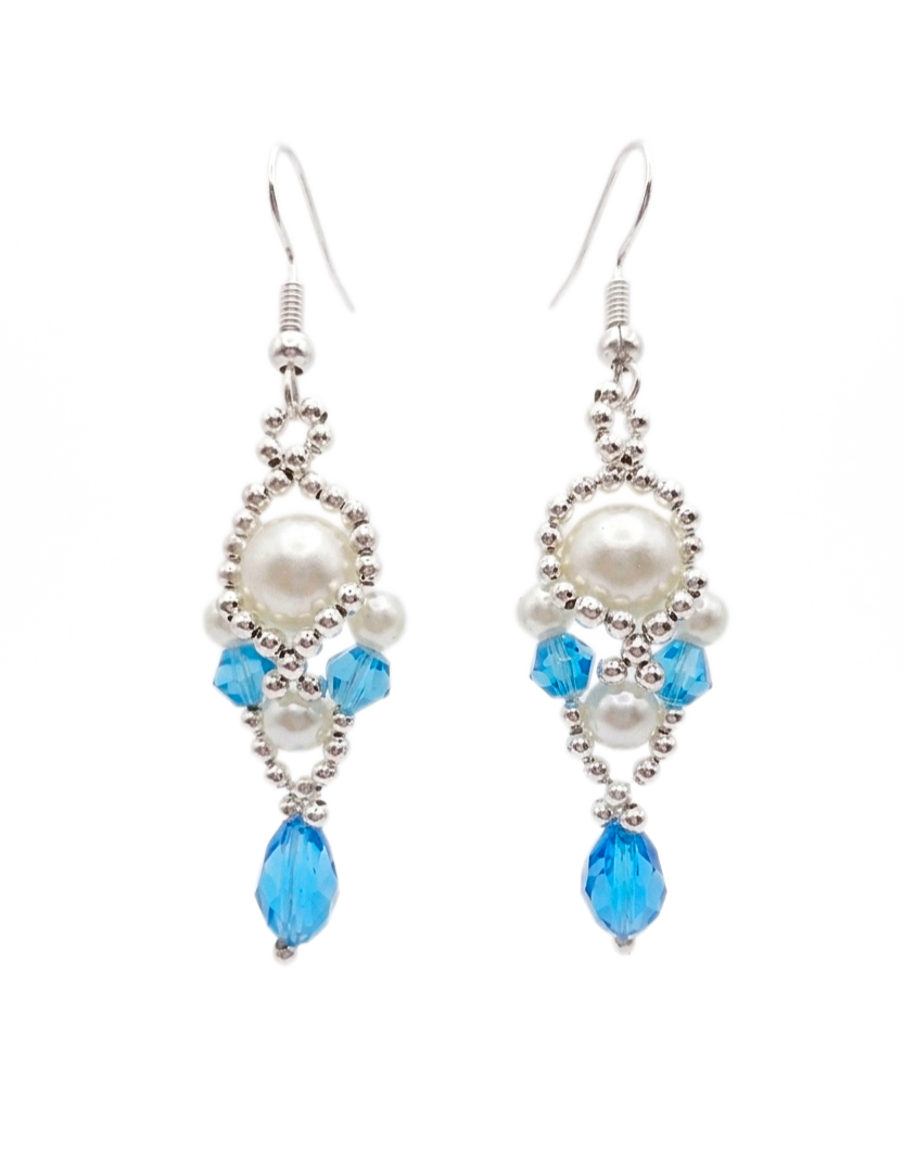aquamarine-drop-pearl-earrings Handmade aquamarine crystal and white pearl dangle earrings with silver-tone beaded frame and teardrop crystal, shown against a white background