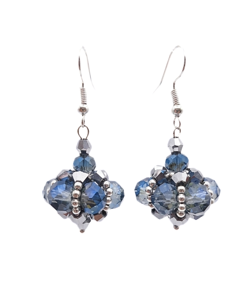 Close-up of handmade drop earrings with translucent blue and smoky-grey faceted crystals and metallic silver crystals woven into a pendulum cluster shape, with silver seed bead accents and silver-toned ear wires, on white background