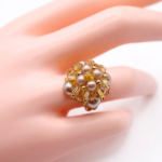 Side view of handmade mocha & champagne pearl and gold crystal beaded cocktail ring on white display stand - handcrafted cluster ring