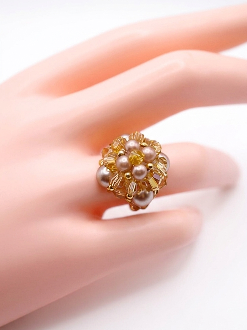 Side view of handmade mocha & champagne pearl and gold crystal beaded cocktail ring on white display stand - handcrafted cluster ring