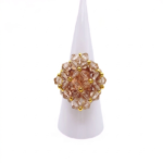 Champagne crystal cocktail ring on white cone display stand - handmade beaded cluster ring with gold accent beads and hidden large crystal centre