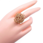 Medium lavender purple crystal cocktail ring worn on mannequin hand - handmade beaded cluster ring with gold accent beads and a hidden large crystal centre.