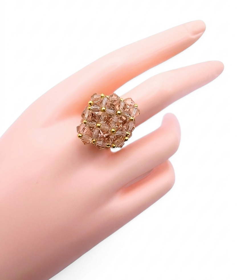 medium-champange-cocktail-hand-display Medium lavender purple crystal cocktail ring worn on mannequin hand - handmade beaded cluster ring with gold accent beads and a hidden large crystal centre.