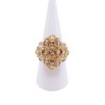 Medium champagne crystal beaded cocktail ring on mannequin hand - handmade cluster ring with gold accent beads and a hidden large crystal centre.