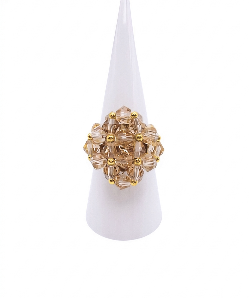 medium-champange-cocktail-ring-display Medium champagne crystal beaded cocktail ring on mannequin hand - handmade cluster ring with gold accent beads and a hidden large crystal centre.