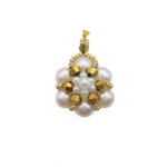 Handmade white pearl and gold-tone crystal pendant featuring lustrous white pearls arranged in a floral cluster with metallic gold faceted crystal accents, small seed pearl centre detailing and a gold-tone bail, photographed on a white background.