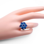 Sapphire blue and aquamarine crystal cluster ring worn on a mannequin hand, showcasing size and fit - handmade statement cocktail ring with silver-tone accents