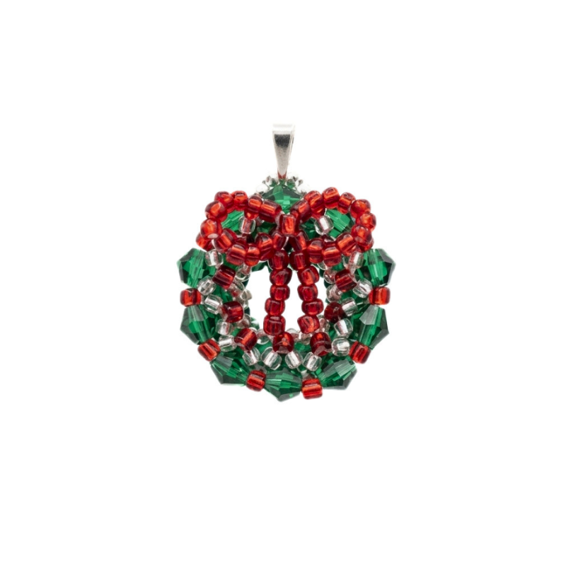 Handcrafted beaded Christmas wreath pendant made with emerald green crystals, red beads, and silver-lined accents, shown against a white background