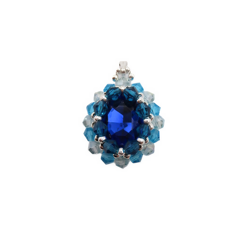 Handmade sapphire blue oval crystal pendant with a large faceted deep blue centre crystal surrounded by aquamarine and light blue crystals with silver bead accents and a silver-tone bail, photographed on a white background.