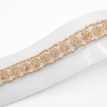 Handmade champagne crystal bracelet featuring faceted crystals and small champagne pearls woven with gold bead accents in an open lattice diamond pattern, displayed flat on a white jewellery stand showing full length and gold-tone lobster clasp with extension chain against a white background.