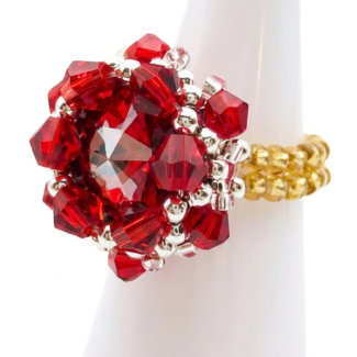 Side profile of red crystal cluster ring with large faceted center stone, red crystals, silver accents and gold beaded band.