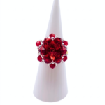 Red crystal cluster cocktail ring with large center crystal on white ring cone stand — handmade beaded statement ring