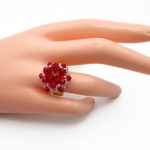 Red crystal cluster cocktail ring worn on mannequin hand showing size and scale --handmade beaded ruby red statement ring