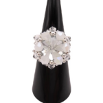 Clear and white crystal cluster cocktail ring with large faceted center crystal and opaque white crystals on black ring cone stand — handmade beaded statement ring