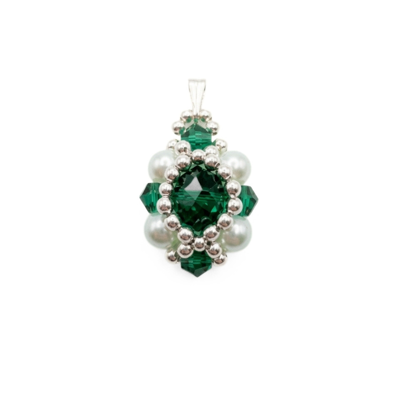 Handmade emerald green crystal pendant with ivory pearls and silver beads on a white background