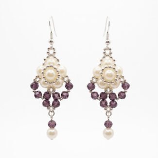 Off-white pearl and amethyst purple crystal drop earrings with faceted purple crystals, silver-toned bead detailing and dangling pearl accents.