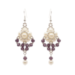 Elegant drop earrings featuring luminous off-white pearls arranged with faceted amethyst purple crystals and silver-toned beads, finished with a dangling purple crystal and pearl on a white background.