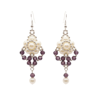 Elegant drop earrings featuring luminous off-white pearls arranged with faceted amethyst purple crystals and silver-toned beads, finished with a dangling purple crystal and pearl on a white background.